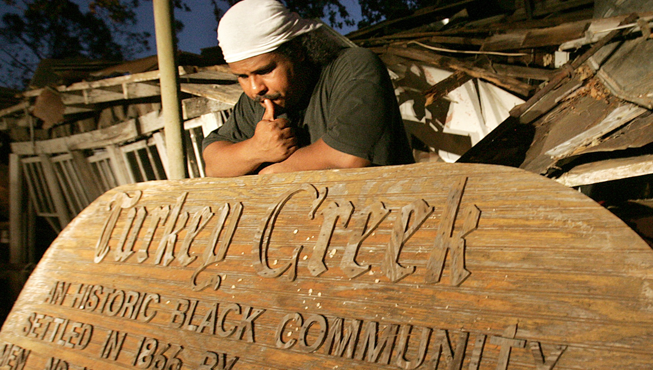 Derrick Evens with the Turkey Creek Historic Community Sign
